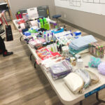 A1 in the community image of table filled with items to fill gift baskets